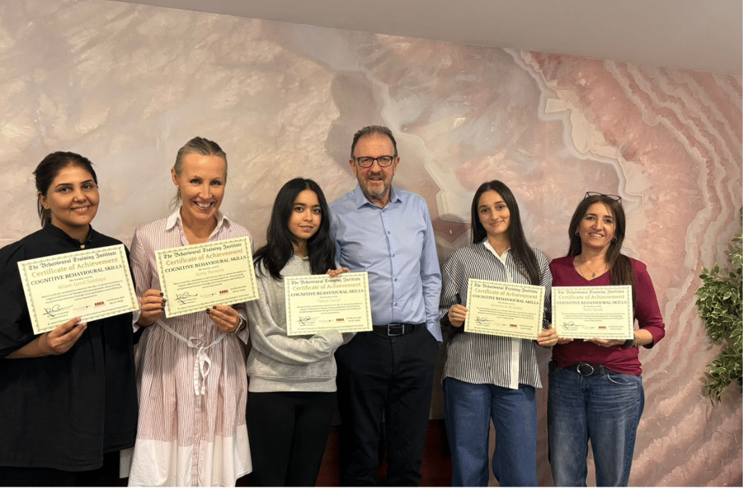 Dr John Crimmins presenting diplomas to course graduates